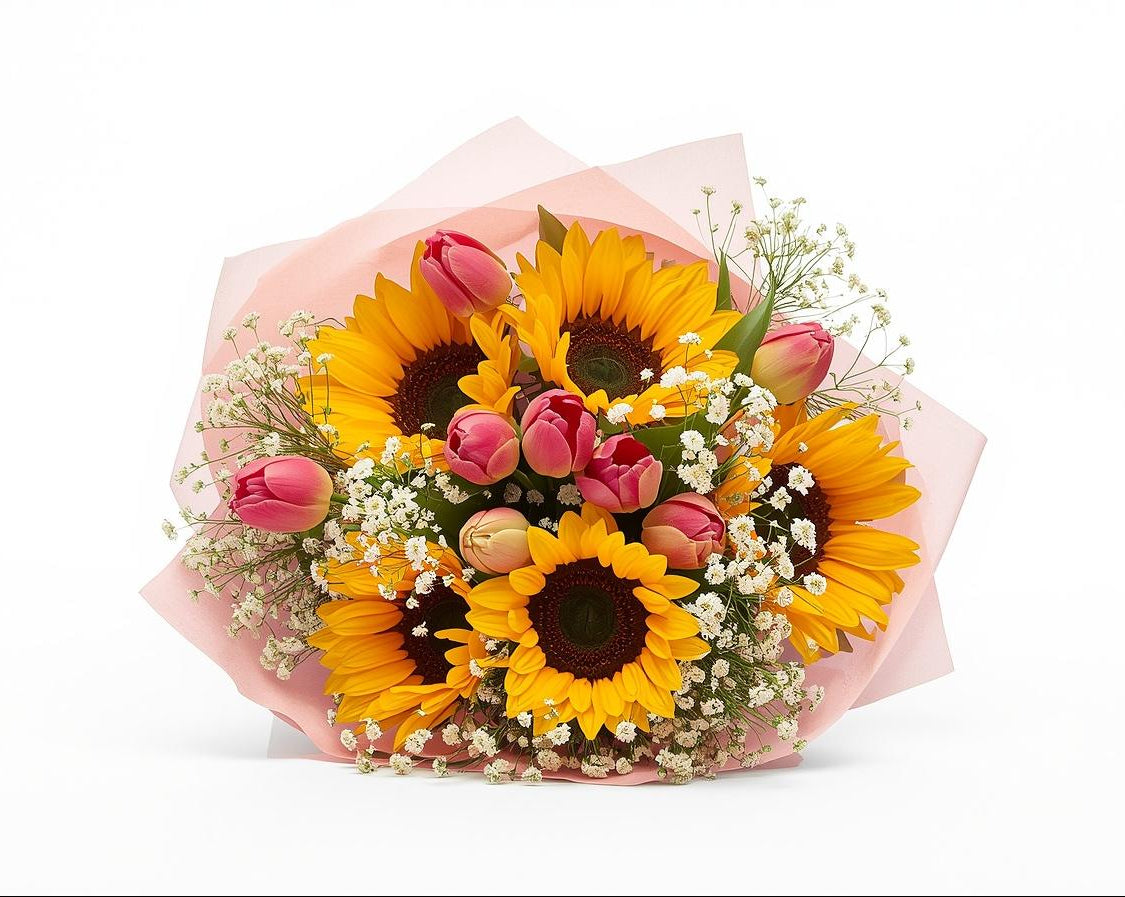 Bouquet of sunflowers and tulips wrapped in pink paper on a white background