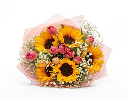 Bouquet of sunflowers and tulips wrapped in pink paper on a white background