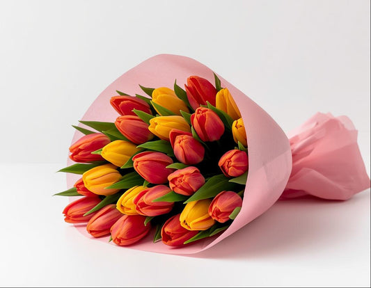 Bouquet of colorful tulips in a pink wrap on a white background
