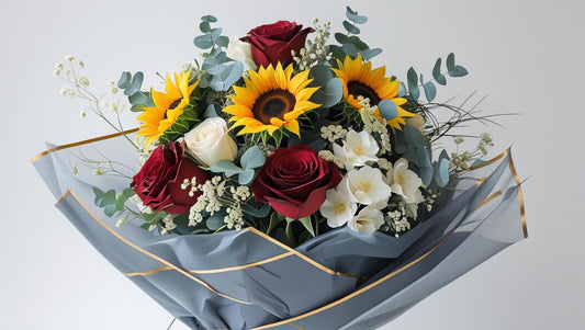 Bouquet of flowers with sunflowers, roses, and eucalyptus on a light gray background